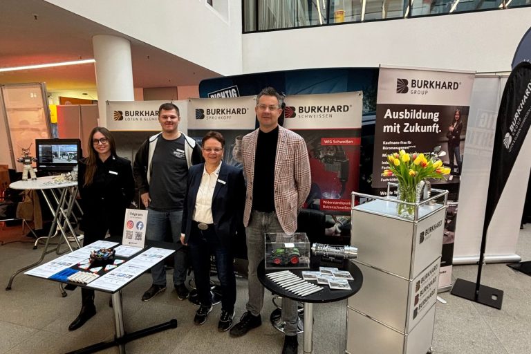 Team der Burkhard Group an einem Messestand in einer Ausstellungshalle